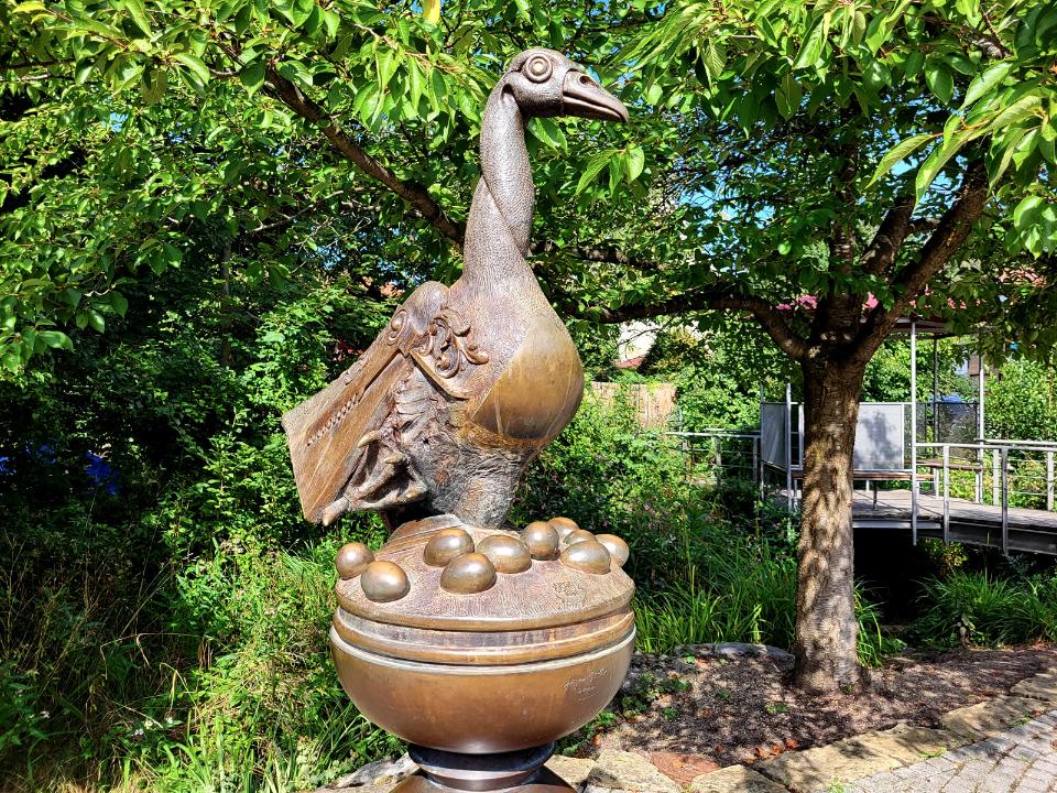 Bronzeplastik einer aufrecht stehenden Gans.