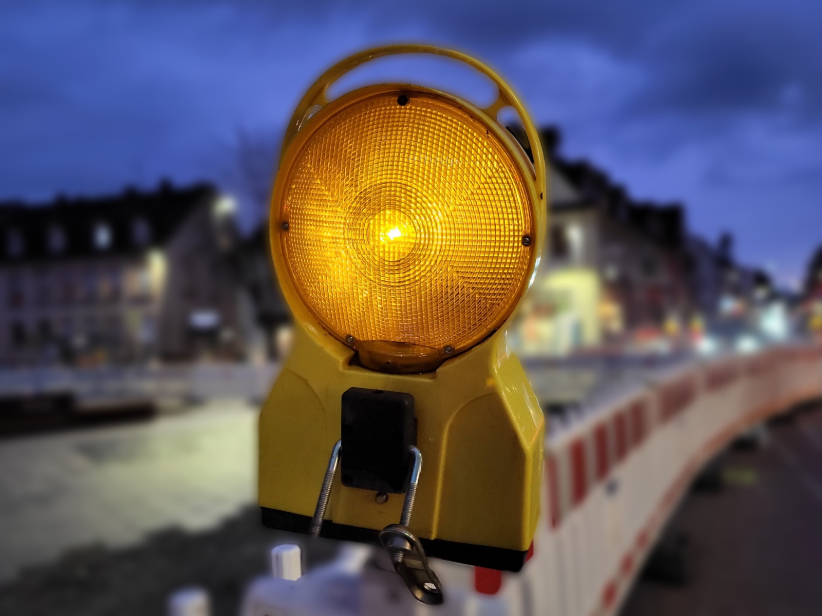 Leuchtende Warnbarke einer Straßensperrung.